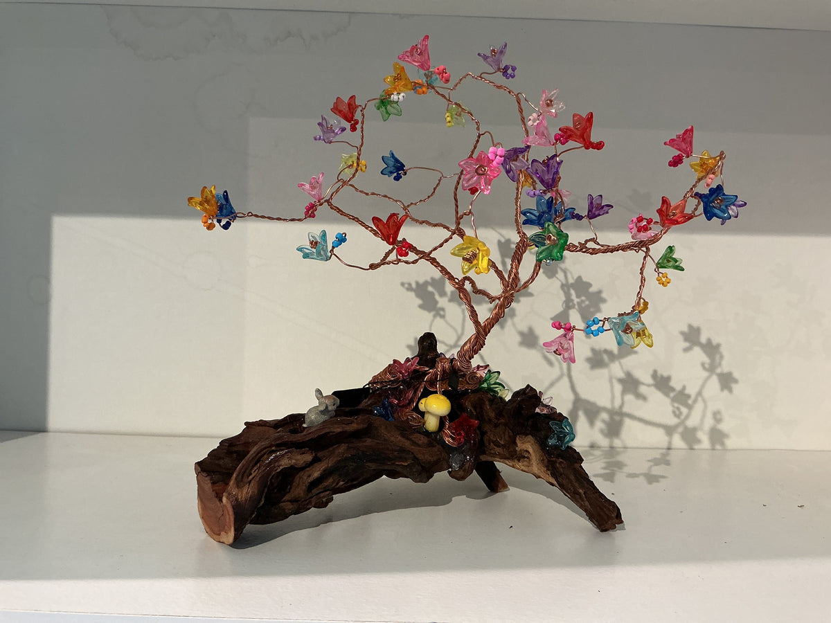 Colorful flowers copper on driftwood with bunny